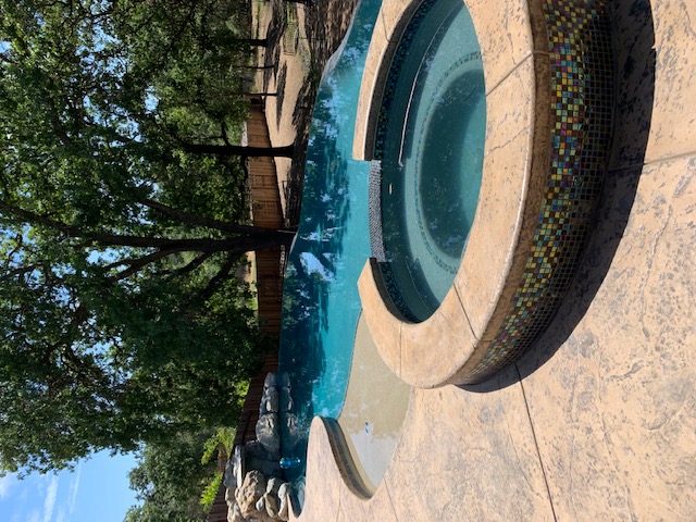 Custom pool with spa and rock waterfall by Pacific Pools